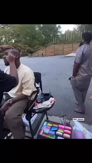  Davido getting his face painted for his