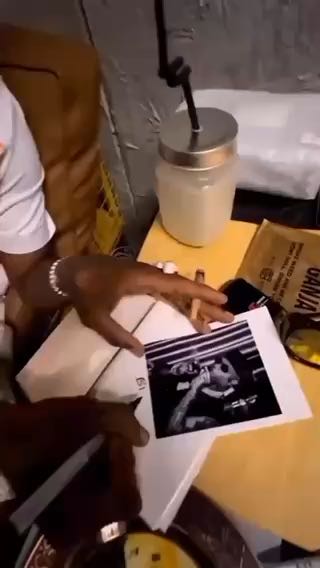  Star Boy signing an autograph for a